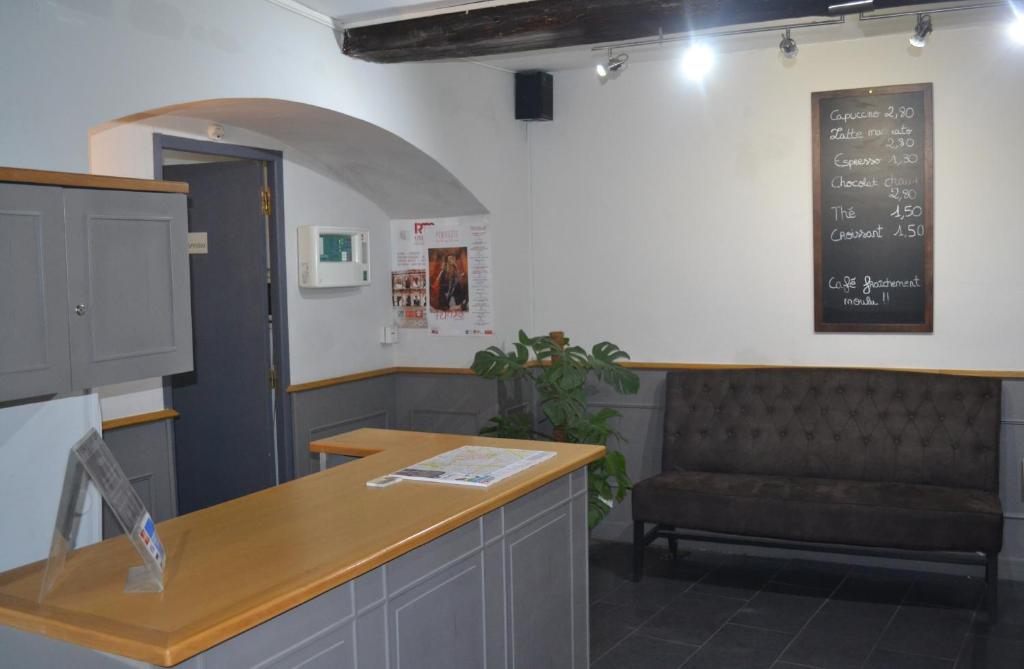 a waiting room with a bench and a chalkboard at Hotel Concorde in Nîmes