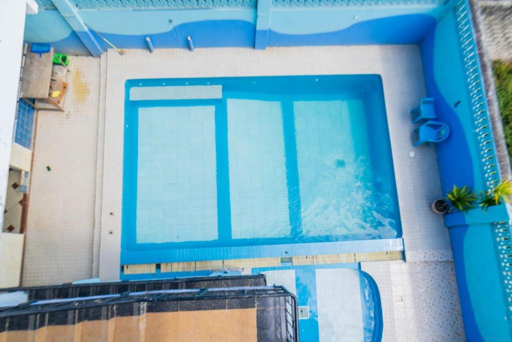 an overhead view of a large swimming pool at Pidows studio apartment in Shanzu