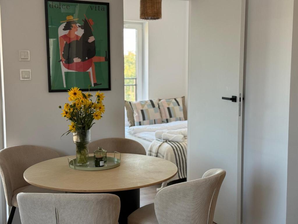 a living room with a table and chairs and a couch at Kościuszki 4 Comfort Suites in Rawicz