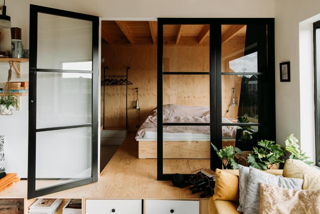 a room with a bed and a large mirror at Familie Buitenhuys Countryside Home with wide landscape views from the bathtub in Oosterleek