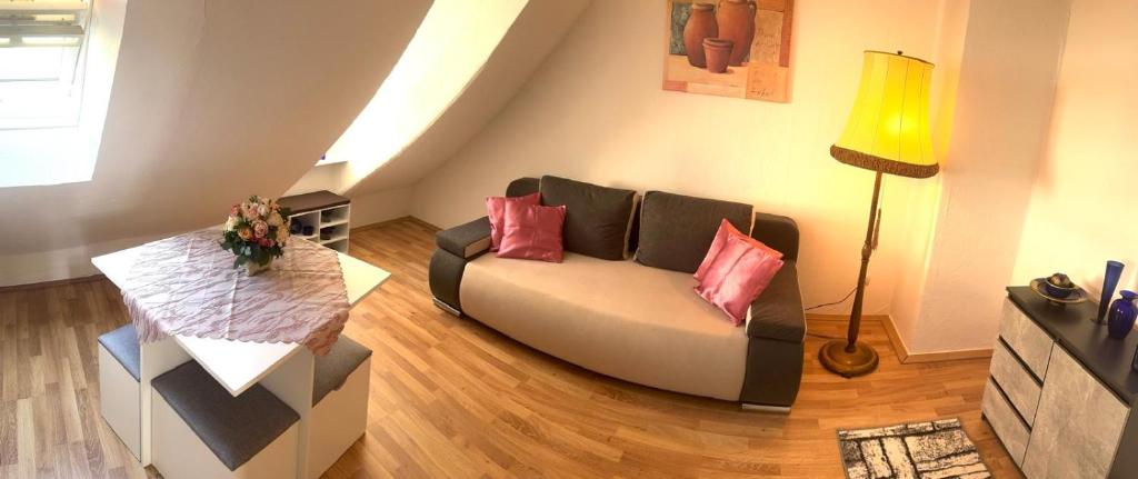 a living room with a couch and a table at Ferienwohnung Fischpforte in Hameln