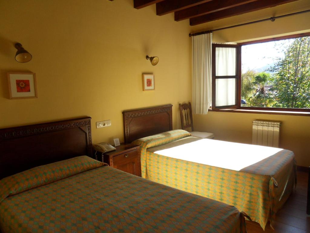 Postel nebo postele na pokoji v ubytování Hotel El Carmen