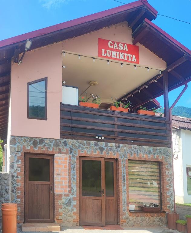 a casa mundina building with a sign on it at Casa Luminita in Brezoi