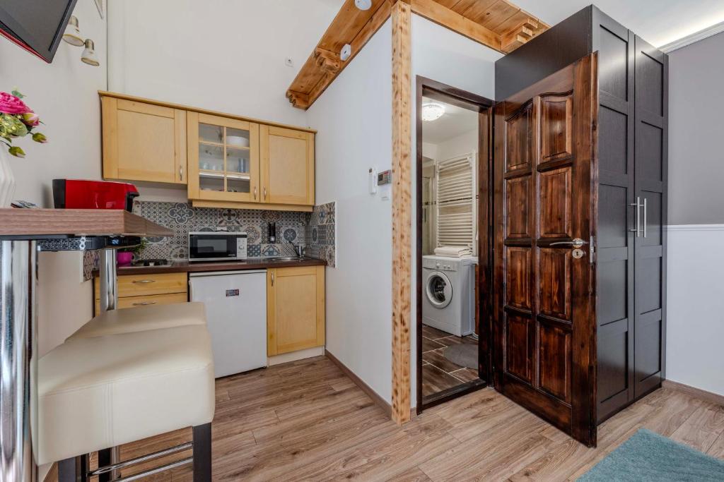 a kitchen with a door open to a kitchen with a sink at Mirage Apartments Váci Street in Budapest