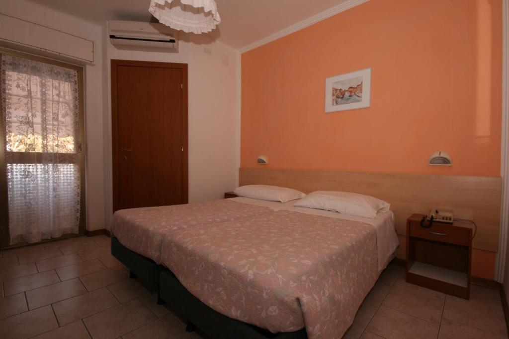 A bed or beds in a room at Hotel Villa Augusta