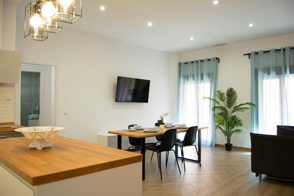 a kitchen and living room with a table and chairs at Torneo 48 Suite in Seville