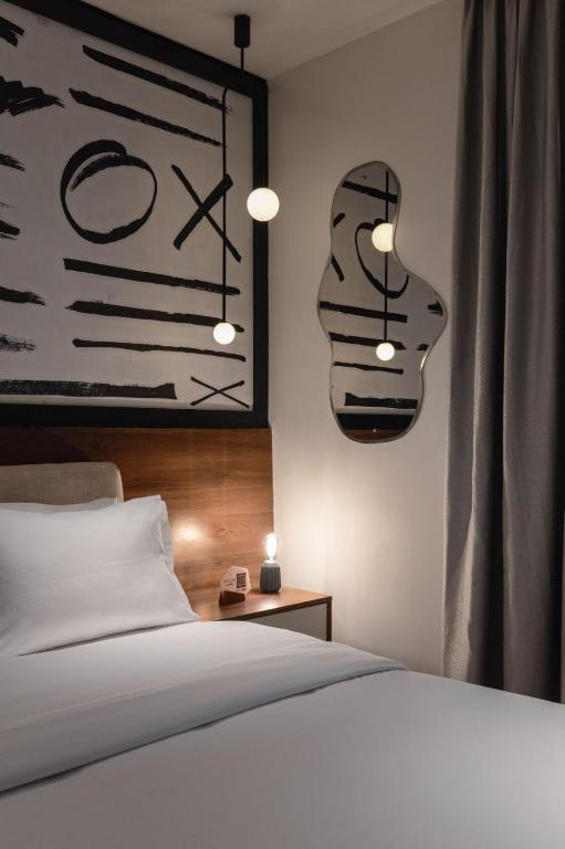 Postel nebo postele na pokoji v ubytování Ivy Lush Hotel