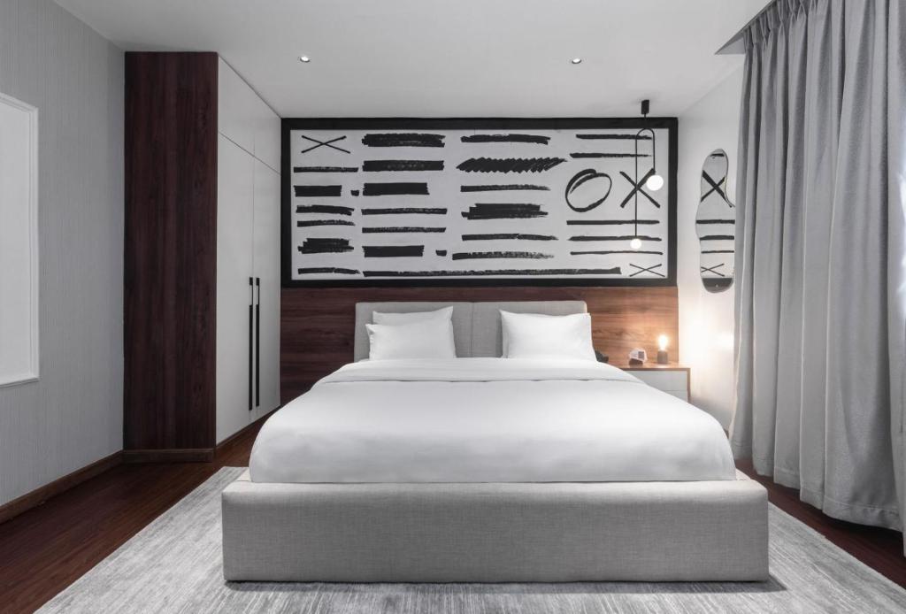 Postel nebo postele na pokoji v ubytování Ivy Lush Hotel