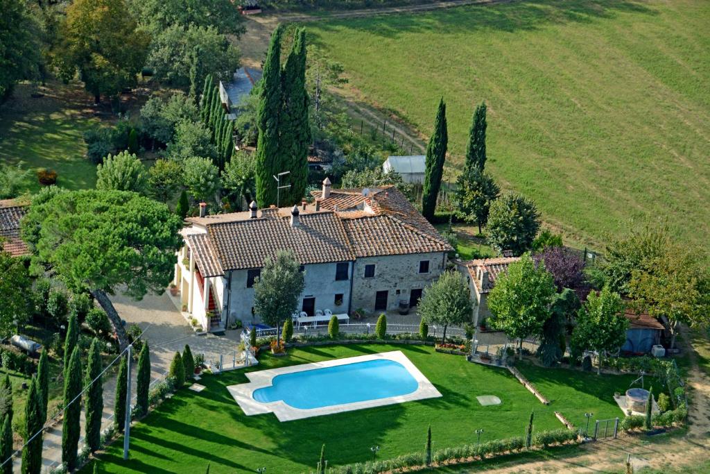 an aerial view of a house with a swimming pool in the yard at Podere Buriano in Arezzo