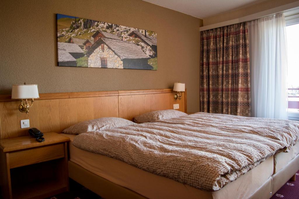 Postel nebo postele na pokoji v ubytování Alpine Classic Hotel