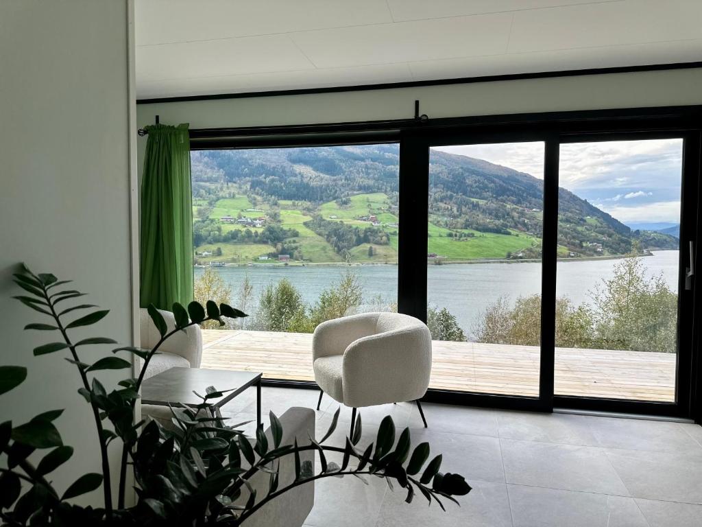 a living room with a view of a large window at Olden Apartment with Panorama view in Olden