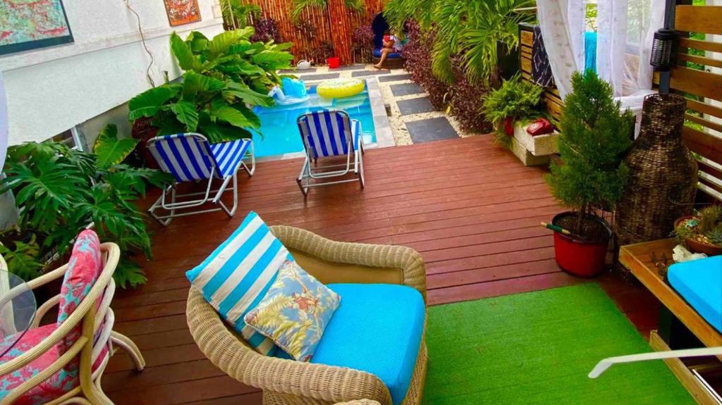 a deck with chairs and a pool in a yard at Have fun with the whole family at this stylish place with smart home features in Christ Church