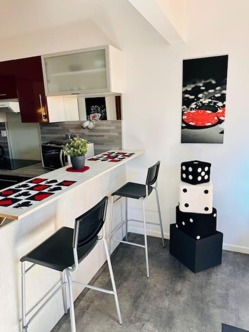 - une cuisine avec 2 chaises et un comptoir dans une pièce dans l'établissement Le LAS VEGAS, à Failly