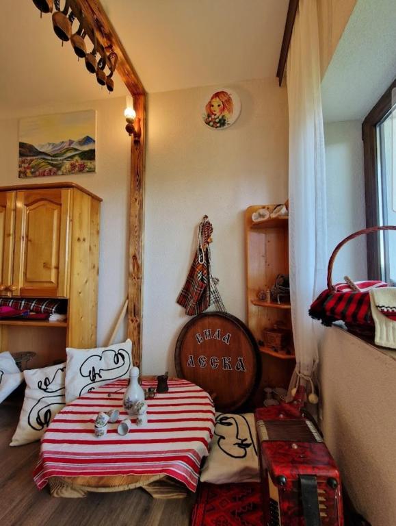 a bedroom with a bed with a striped blanket at Вила Леска in Leska