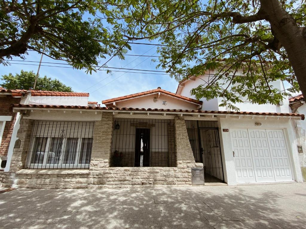 a large white house with a garage at Casa Miriam - Casa En Miramar Para 4 PAX Con Cochera - Hola Sur in Miramar