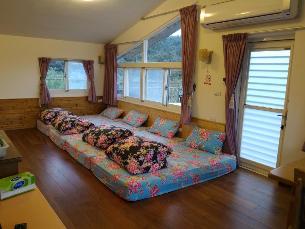 a large couch in a room with windows at Liang Chen Mei Jin B&amp;B in Shuangxi