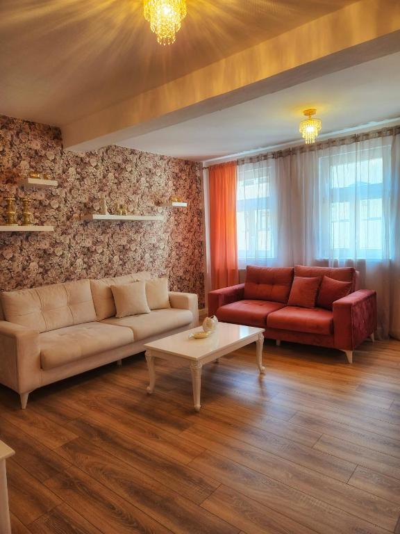 a living room with two couches and a coffee table at Appartements am Bachhaus in Eisenach