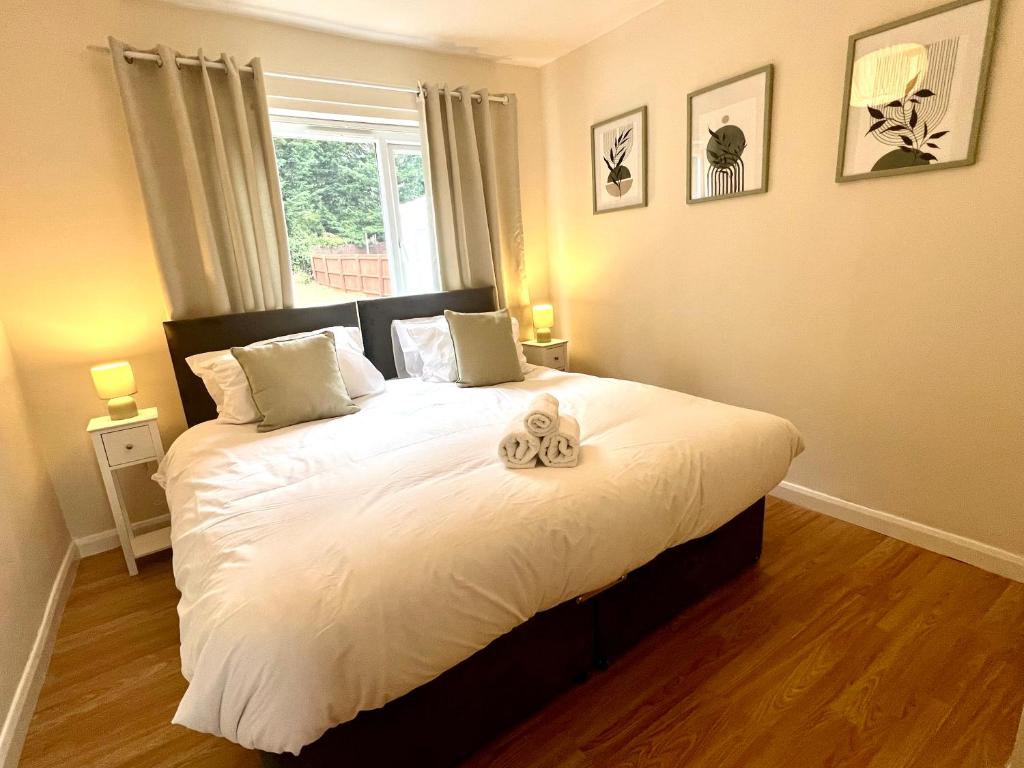 a bedroom with a bed with two stuffed animals on it at The Olive House - 4 Bedroom, Sleeps 8, Contractors Welcome in Middlesbrough