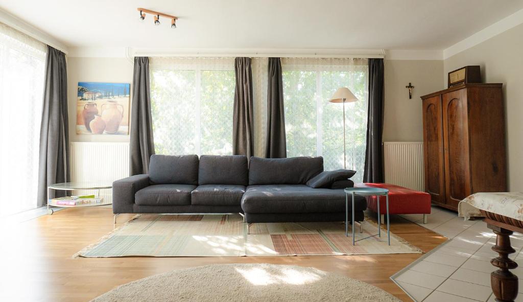 a living room with a couch and a table at Tea Apartman Balatongyörök in Balatongyörök