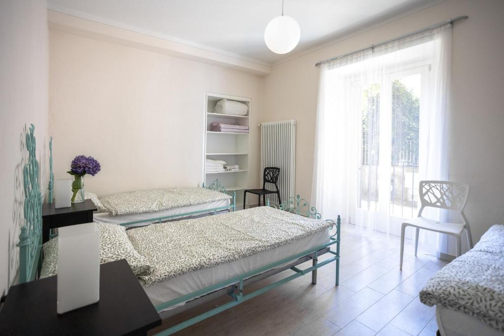 a bedroom with two beds and a window at Appartamento Gino in Cannero Riviera