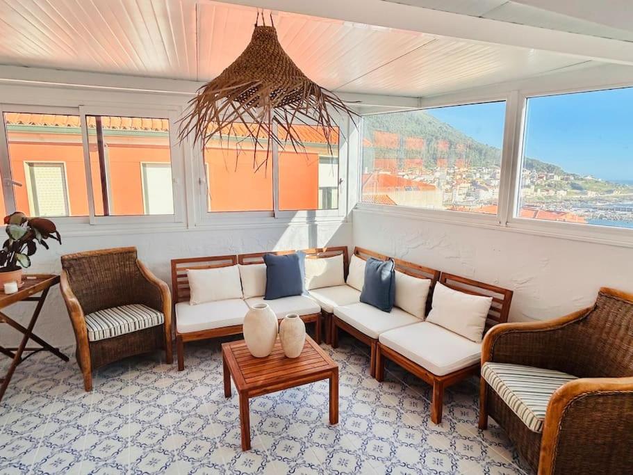 a living room with couches and chairs and a table at La Casita de las Vistas in A Guarda