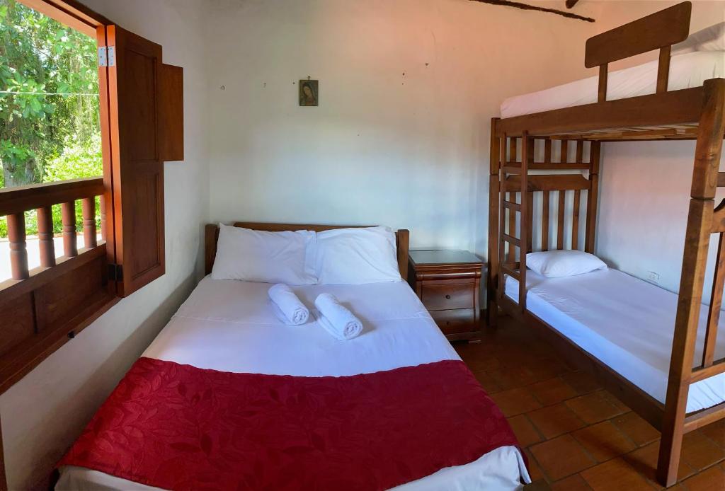 Postel nebo postele na pokoji v ubytování Hostal Villa San Rafael