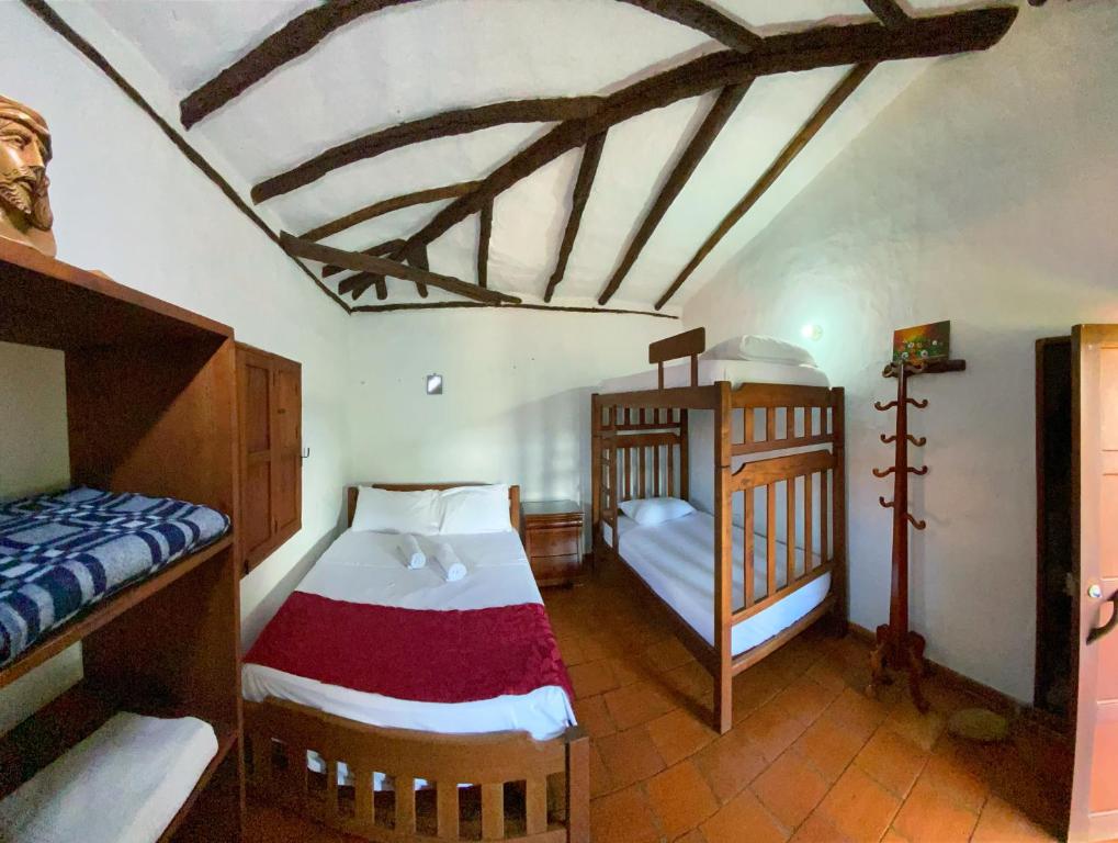 Postel nebo postele na pokoji v ubytování Hostal Villa San Rafael
