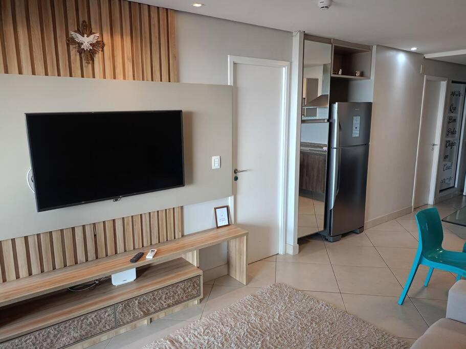 a living room with a flat screen tv on a wall at landscap Meireles Fortaleza in Fortaleza