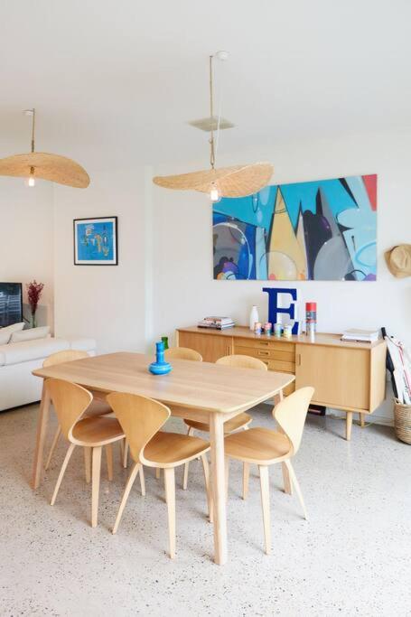a dining room with a wooden table and chairs at Ripple at Port Willunga in Port Willunga
