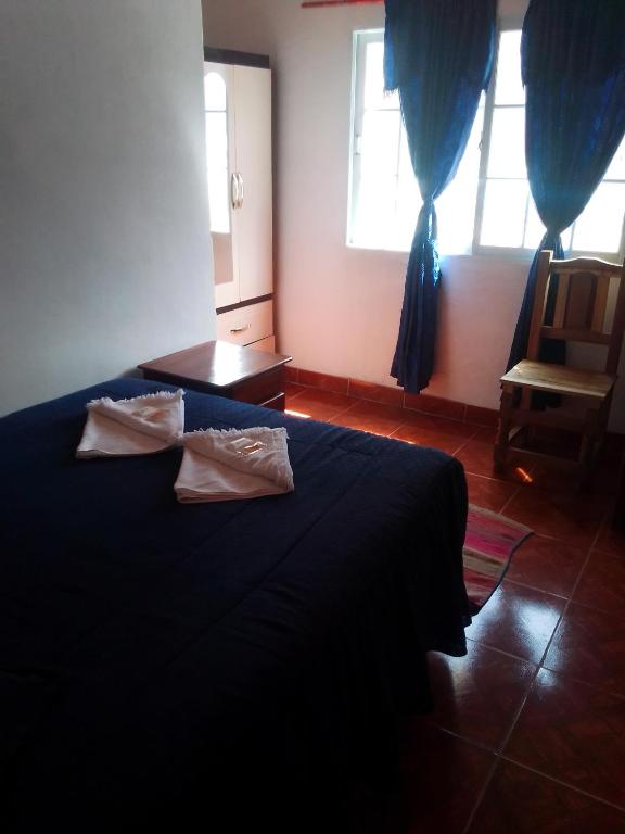 Postel nebo postele na pokoji v ubytování Hostal del Luna