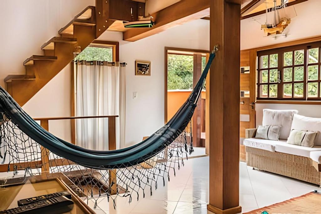 uma rede na sala de estar de uma casa em Morada dos Pássaros | Pertinho da Praia do Curral em Ilhabela