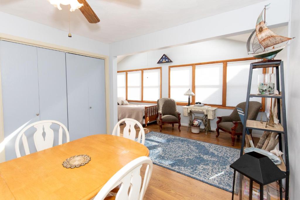 a dining room and living room with a table and chairs at Bluebirds Road to Happiness in Vermilion