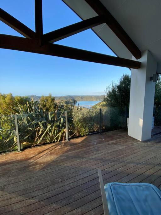 a deck with a chair and a view of the water at Russell's Secluded Secret in Russell