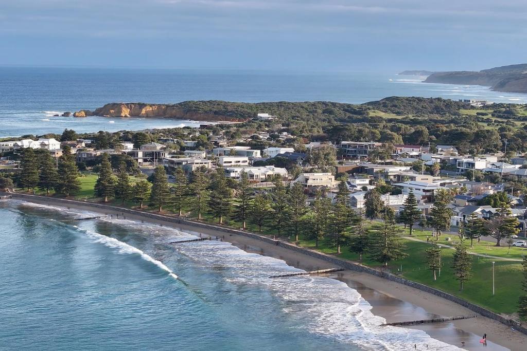 an aerial view of a beach with houses and the ocean at Cosy Esplanade Unit 8 Steps to Beach & Cafes in Torquay