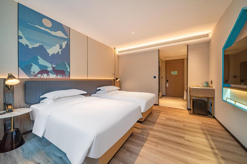 Postel nebo postele na pokoji v ubytování Echarm Hotel Guangzhou Baiyun Station Julong Metro Station