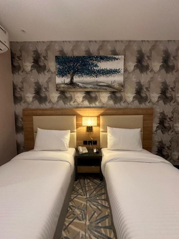 Postel nebo postele na pokoji v ubytování SKY PARK HOTEL