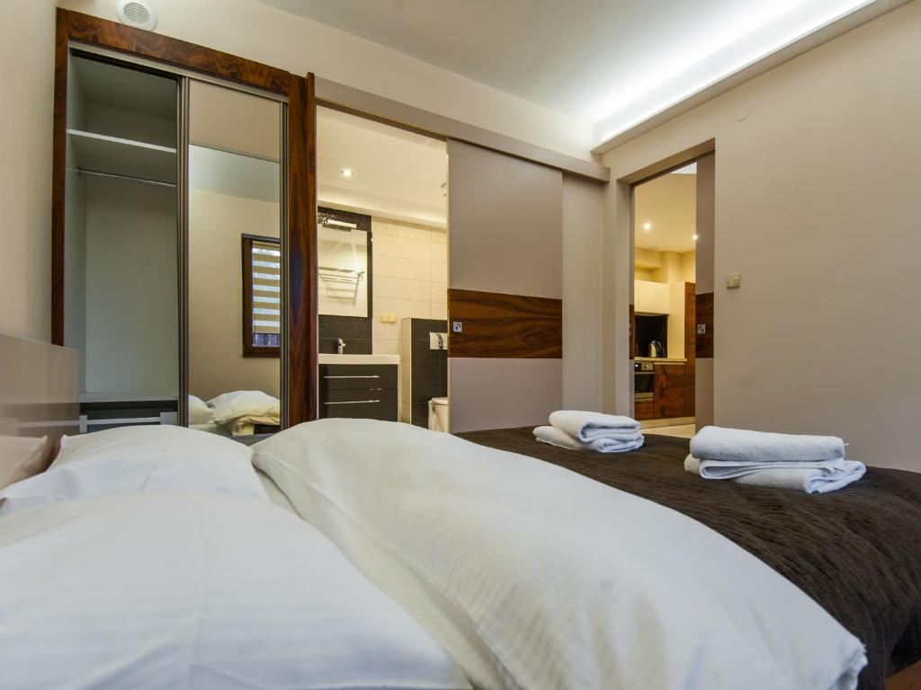Posteľ alebo postele v izbe v ubytovaní Apartamenty Domino - Zakopane