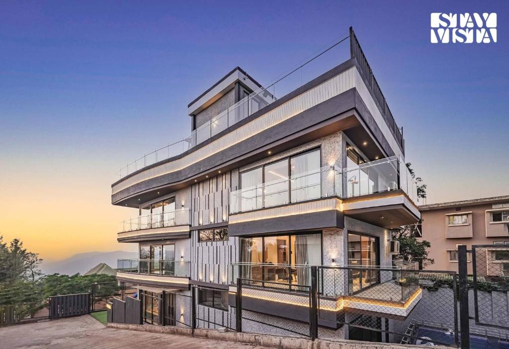 an image of a house with a view at StayVista at Grande Prima - Pool, Theatre Room & BBQ in Panchgani