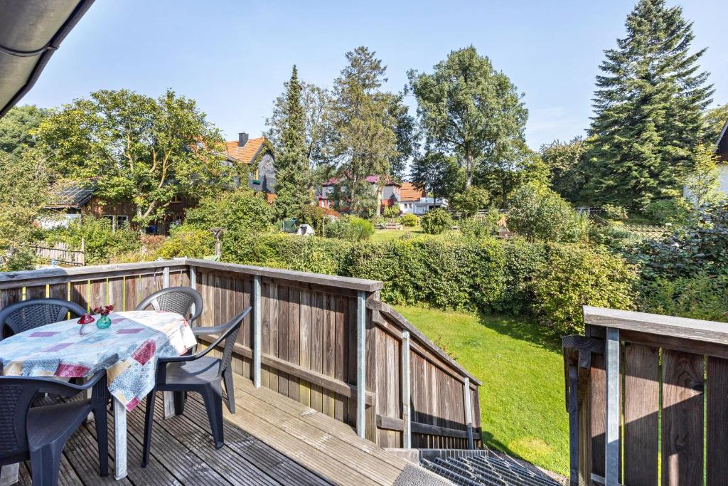a patio with a table and chairs on a deck at Ferienwohnung Spormann in Braunlage