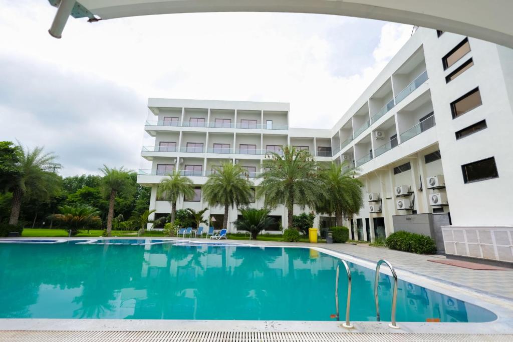 a swimming pool in front of a building at Arawali Ananta Elite, Ranakpur in Sādri