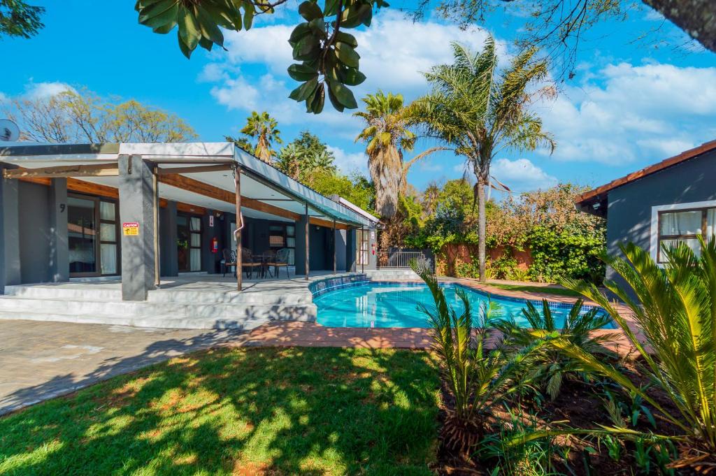 una villa con piscina y una casa en ADAIA GUEST House, en Johannesburgo