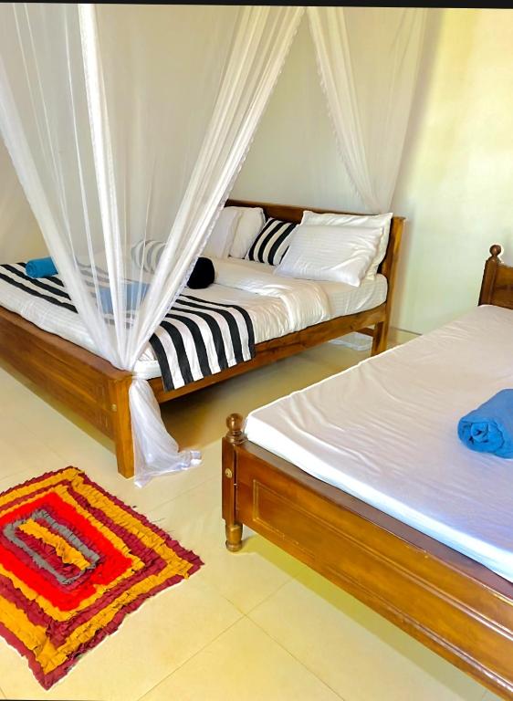 Postel nebo postele na pokoji v ubytování Sadew Home Stay