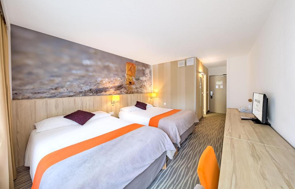 a hotel room with two beds and a painting on the wall at Mercure Gdańsk Posejdon in Gdańsk