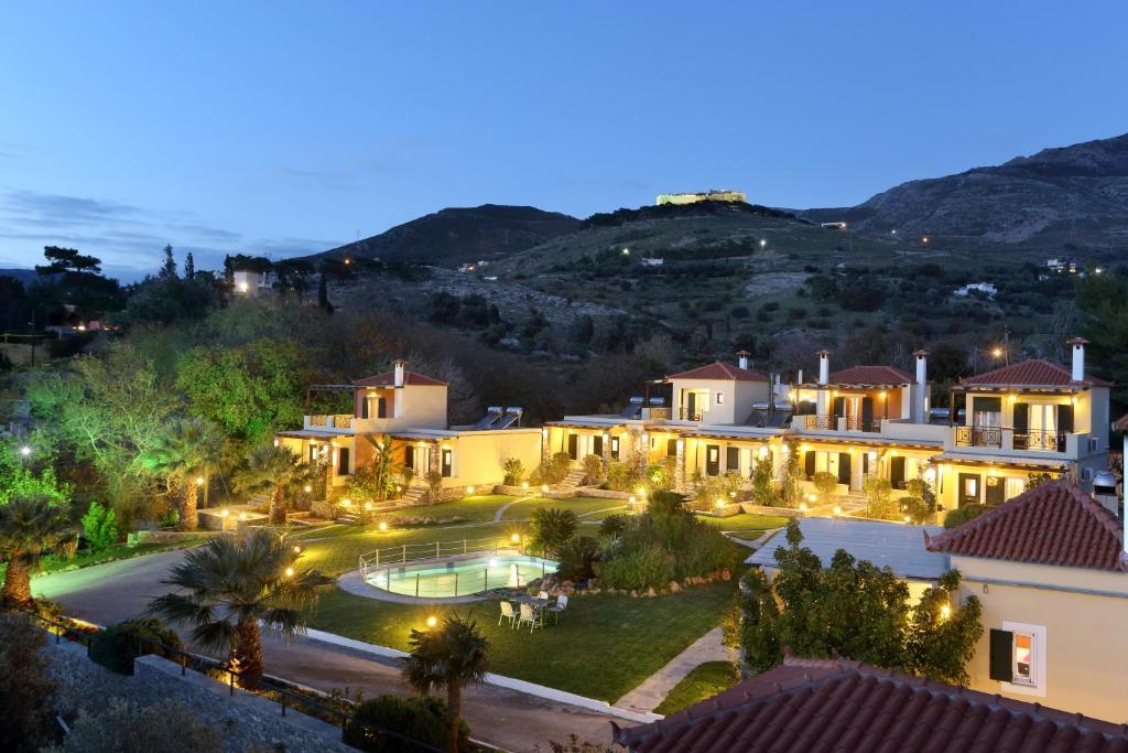 an aerial view of a house with a pool at night at Politia Villas in Karistos