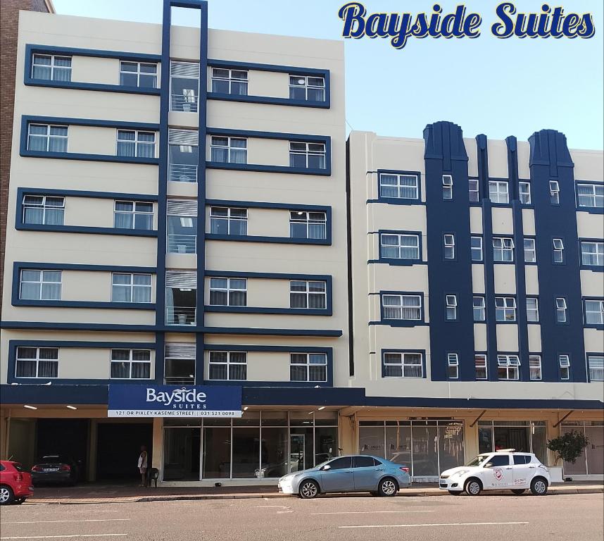 a large building with cars parked in front of it at Bayside Hotel Suites in Durban