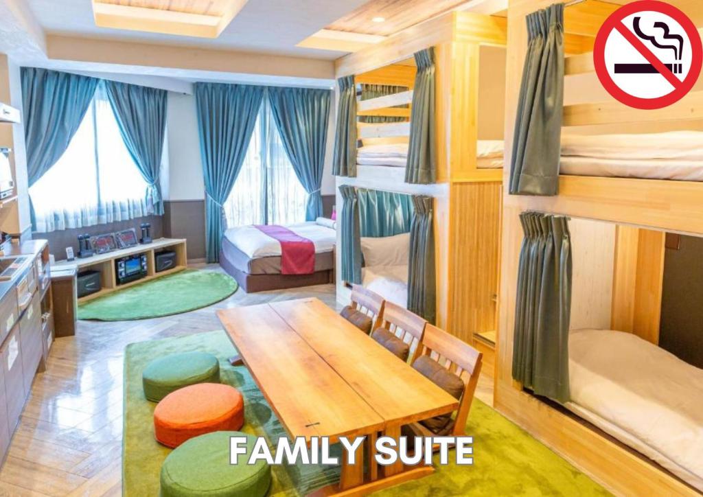 a room with a dining table and bunk beds at Hotel Pasela Living Shinjuku in Tokyo
