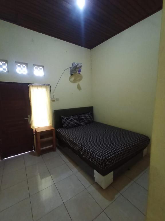 Postel nebo postele na pokoji v ubytování Kelana Guest House