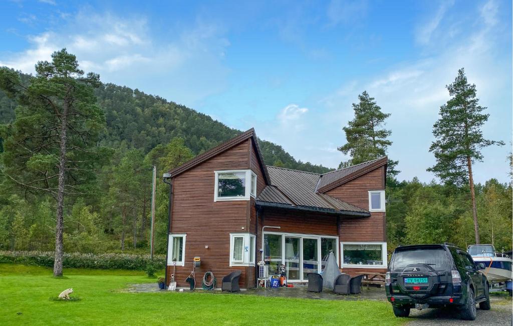 a house with a car parked in front of it at Beautiful Home In Skodje in Vatne