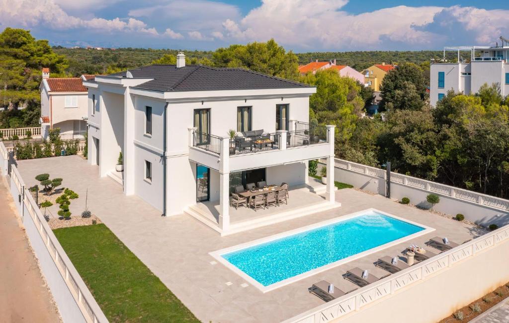 an aerial view of a house with a swimming pool at Stunning Home In Petrcane in Petrcane