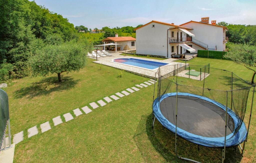 an aerial view of a backyard with a trampoline at Amazing Home In Labin in Labin